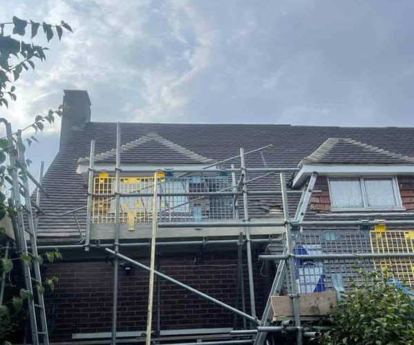 This is a photo of a roof with two dormers that is having some damaged tiles replaced. Works carried out by GKL Roofing Tickhill